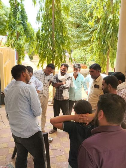 A group of farmers gathers around our demonstration setup during a village meeting. We encourage questions and discussions to ensure everyone leaves with a clear understanding of how our smart irrigation can be implemented on their own farms.