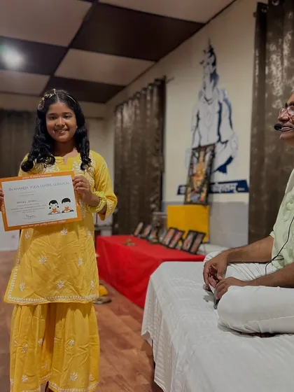 A young graduate proudly displays her certificate. It is so rewarding to see their confidence grow throughout the week.