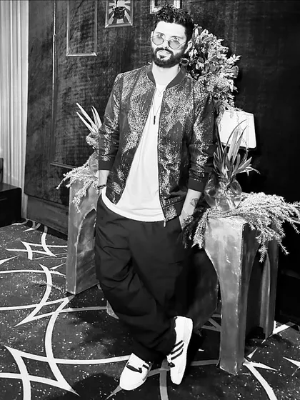 A stylish black and white shot of me in a bomber jacket and joggers. A cool, urban look for a gig.