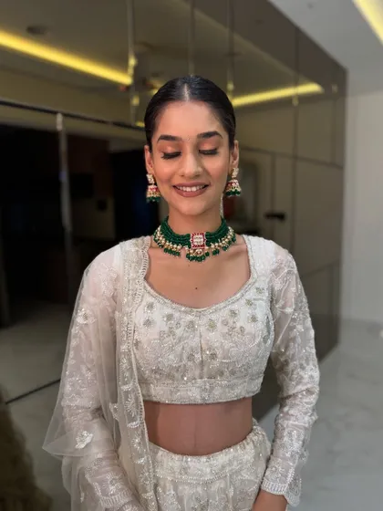 A happy, smiling close-up. The makeup is fresh and minimal, with a pop of color from the green choker, showing that sometimes less is more.