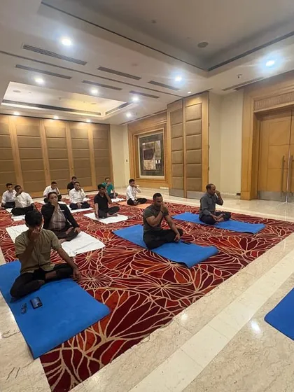 An instructor demonstrates a pranayama (breathing technique) to the staff at Radisson Hotel. These simple yet powerful exercises can be easily integrated into a daily routine to manage stress.
