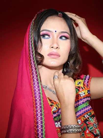 A vibrant Navratri makeup look. I used a bright pink and blue dual-toned eyeshadow to match the colorful outfit, creating a fun and festive look perfect for a night of dandiya.