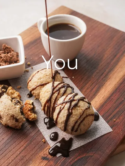 A beautiful shot of my gluten-free Lava Cookies being drizzled with chocolate sauce. This is a treat you won't believe is healthy.