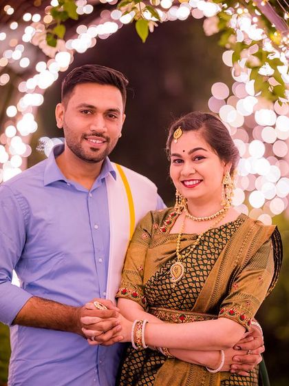 A happy couple in traditional attire posing in the light tunnel, showing the versatility of the set.