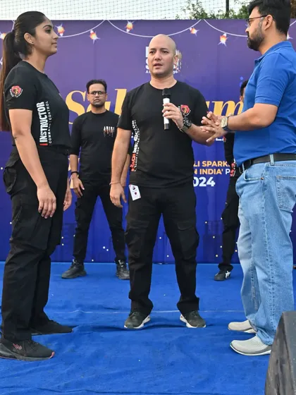 Explaining the nuances of a defensive stance during a live presentation. Our workshops are not just demonstrations; they are interactive learning sessions.