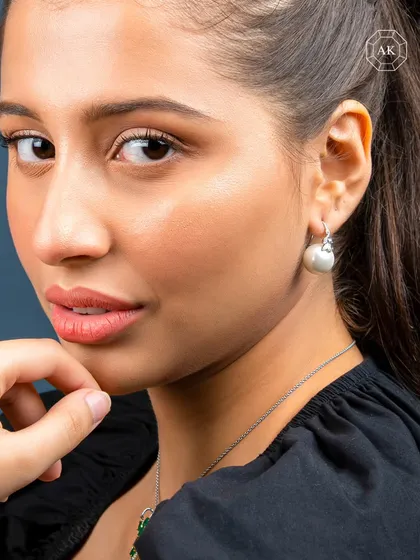 Some treasures aren’t just worn, they are felt. This image of a model wearing our simple pearl drop earrings embodies our belief that luxury should feel personal, not distant.