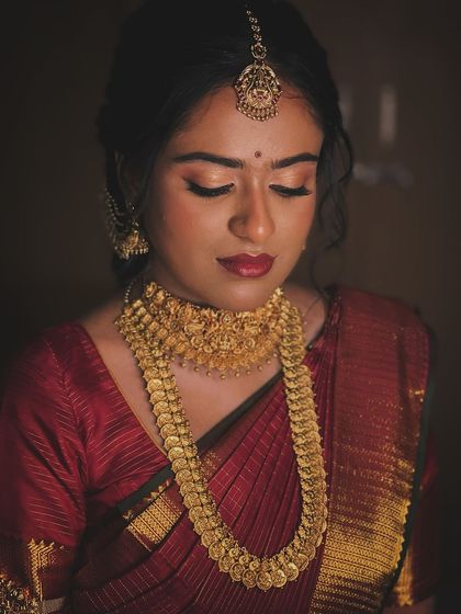 An artistic, low-light shot that creates a moody and romantic feel, highlighting her features.