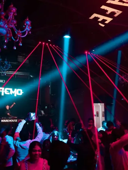 Red laser beams crisscross over the dance floor at Warehouse Cafe, creating a classic rave aesthetic.