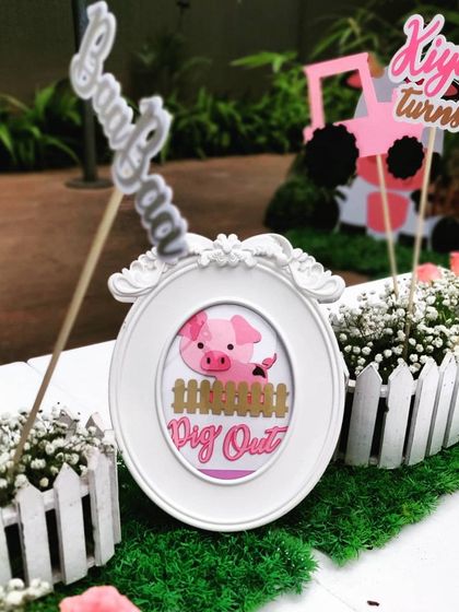 Themed table decor helps tie everything together. This small, framed piglet picture and custom "Baa Baa" sign are part of the detailed centerpieces that make our farm parties so special.