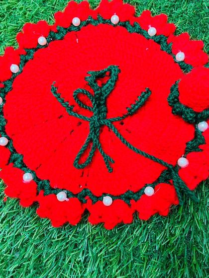This special red poshak features the 'Ek Onkar' symbol crocheted in green. It is a heartfelt creation, perfect for celebrating Gurpurab or for any devotee who holds the symbol dear.