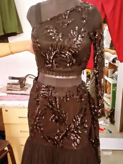 Another angle of the one-shoulder sequin saree, showing the single detailed sleeve. This is a great rental option for a glamorous, modern look.