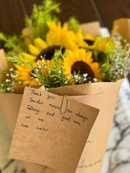 A beautiful bouquet of sunflowers from Laika, with a note saying "Thank you, Teacher ma'am, for always taking such good care of me."