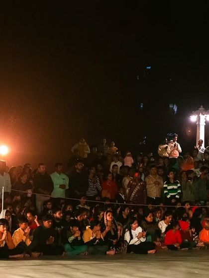 Candid shots of the priests and the large crowd of devotees during the Maha Aarti at JK Temple, capturing the community and shared experience of the event.