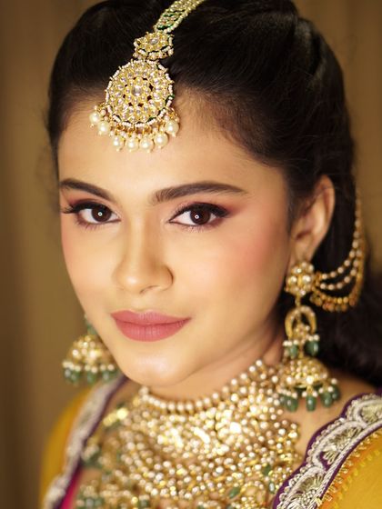 For Safaagaa, we chose soft rose tones for the eyes and a velvet matte lip. This look was designed to enhance her natural beauty and complement her regal jewels without ever overpowering her radiant smile.