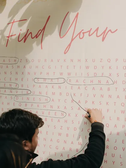 A giant 'Find Your Name' word search for the seating chart. This is a creative and playful way to guide guests to their seats, turning a logistical detail into a fun experience.