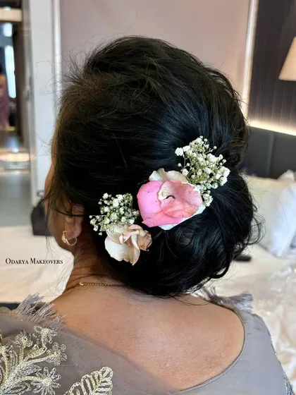 A soft and romantic floral bun for a grandmother. It's a graceful and age-appropriate hairstyle that looks beautiful.