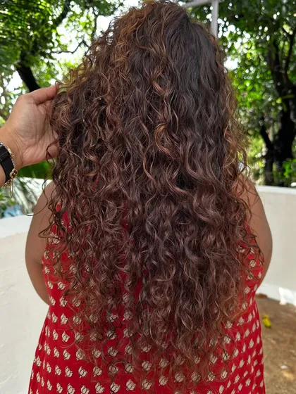 Once you embrace your curls, you never go back. For her new job, we did a haircut to reshape her curls and added highlights to make them stand out.