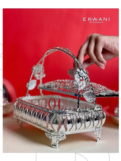 A touch of grandeur for your festive spread. This rectangular silver serving basket, with its ornate floral handle and intricate cutwork, is more than just serveware, it is a statement.
