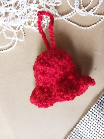 A cute red crochet bell ornament to ring in the holiday cheer.
