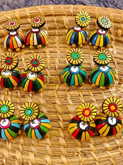 A collection of my striped jhumkas, each hand-painted with colorful bands.