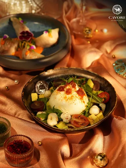 A plate that demands your full attention. Here, a creamy Burrata sits among fresh greens, ripe tomatoes, and avocado, ready to be dressed with infused oils. It’s a quiet performance of flavour and texture.