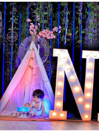 Celebrate your baby's first milestone with a memorable cake smash or birthday photoshoot. We provide themed setups like this one, complete with large 'ONE' marquee letters and a safe, fun environment for your little one.