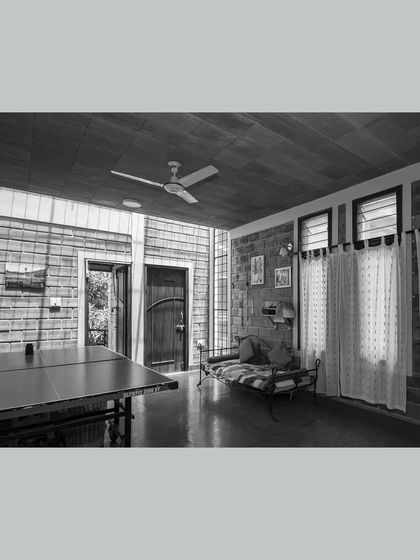 This multipurpose family room is designed for flexibility, serving as a space for recreation and relaxation. A large skylight and full-height window ensure the room is filled with natural light throughout the day.