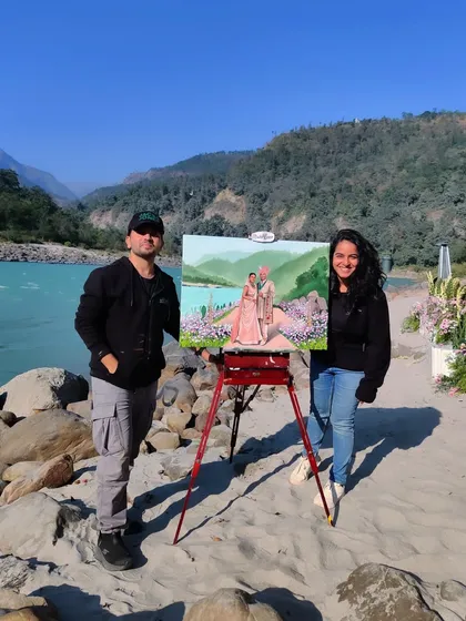 Us with our finished artwork by the Ganga in Rishikesh. This destination wedding was a dream, combining nature's beauty with a beautiful celebration.