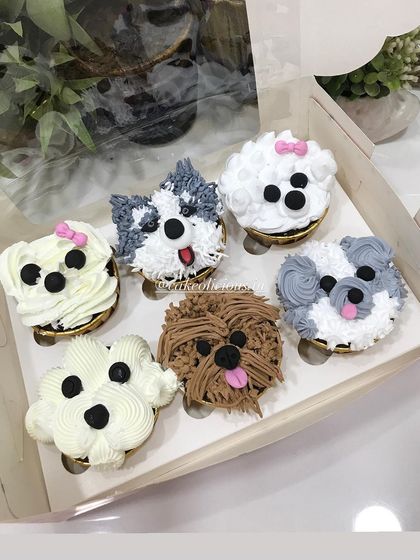 A set of six puppy-faced cupcakes, each with a unique design and expression. I use different piping techniques to create realistic fur textures, making them an adorable treat for any dog lover.