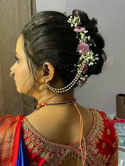 A side profile showing how the hairstyle, ear chain, and makeup come together harmoniously.