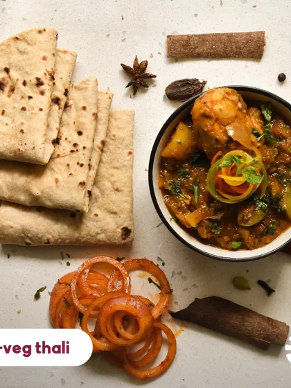 For those who enjoy a hearty non-vegetarian meal, my non-veg thali is the perfect choice. It features a succulent home-style chicken curry, prepared with aromatic spices, served with soft rotis and onion salad.