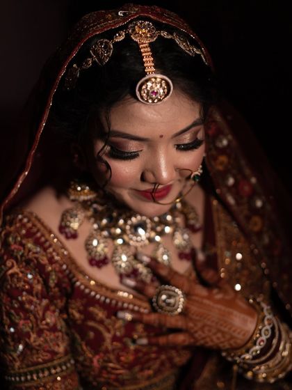 A moment of quiet reflection, with the bride's hand on her heart. This image is filled with emotion and highlights her stunning bridal jewelry.