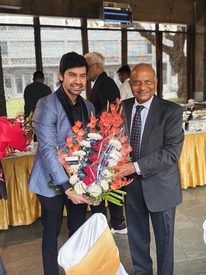 Presenting a bouquet to Senior Advocate Mr. Pravin H. Parekh on his 80th birthday.