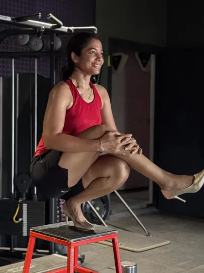 Who says you can't be strong and stylish? This photo captures the fun side of fitness, showing that the strength and balance you build in the gym, like with this pistol squat on a box, carries over into every part of your life.