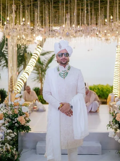 The groom looking dapper and ready for his ceremony. I ensure the decor, like this stunning mandap with hanging crystals, provides a regal backdrop for his portraits.