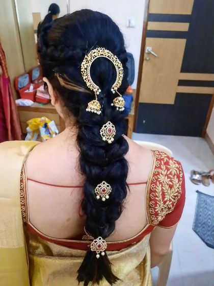 A classic leaf braid, also known as a fishtail braid, decorated with stunning gold hair accessories. This style is perfect for brides who want a traditional yet intricate look.