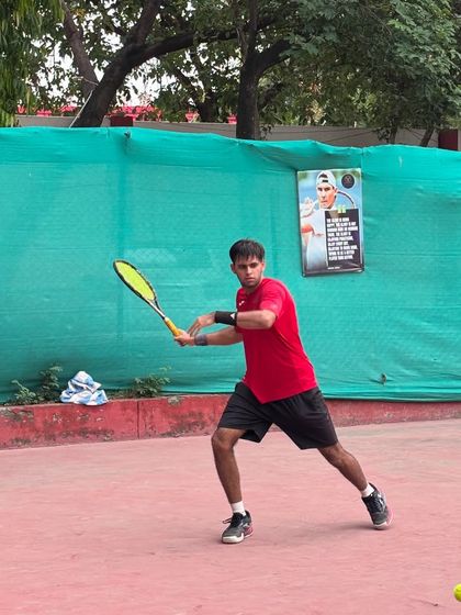 A player focused during a hitting session, demonstrating the powerful form we build at SlamQuest.