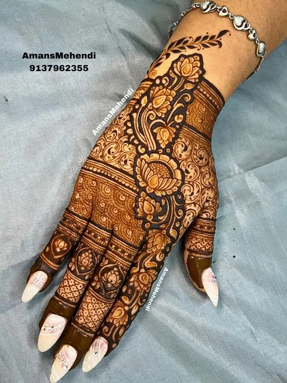 This is an example of a detailed floral design for the back of the hand. I use bold lines and delicate shading to make the flowers and leaves stand out, creating a rich, textured look perfect for any celebration.