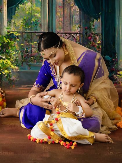 A tender moment of a mother adjusting her child's pearl necklace. This detailed shot focuses on the loving interaction and traditional accessories.