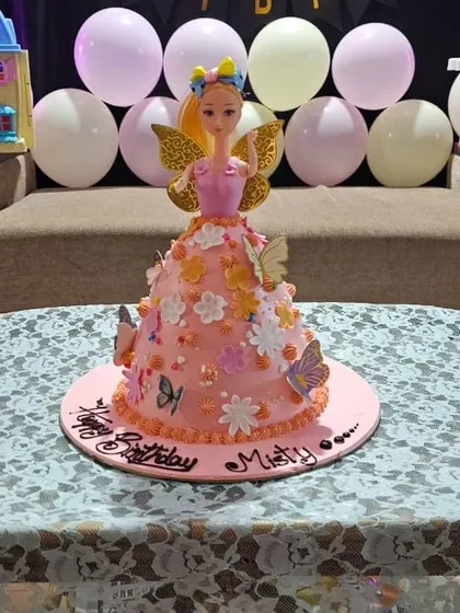 The Barbie doll cake in its party setting, ready to make a little girl's birthday wish come true.