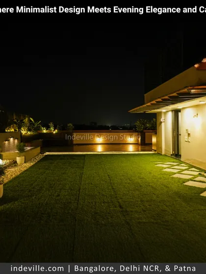 Showcasing a minimalist and elegant terrace design. The combination of a manicured turf lawn, clean stone lines, and strategically placed ambient lighting creates a sophisticated and warm atmosphere perfect for evening relaxation.