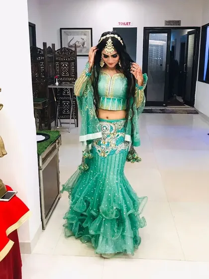 A full frontal view of the stunning sea-green ruffled lehenga.