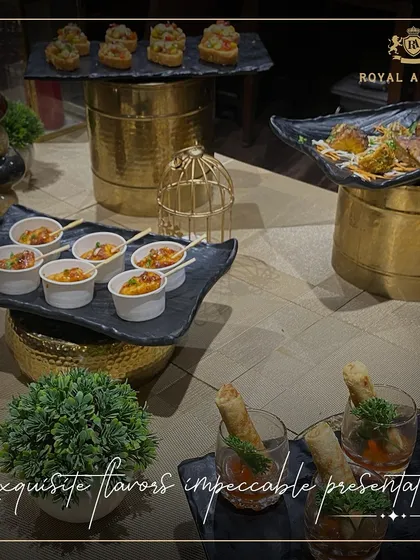 I focus on exquisite flavors and impeccable presentation. This appetizer station features a variety of small bites, including spring roll shooters and savory cups, all displayed on elegant tiered stands with gold accents.
