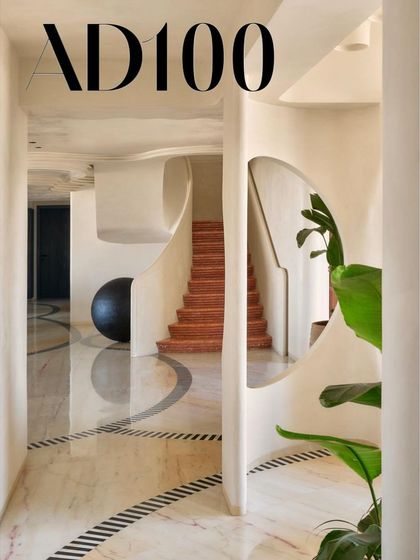 A hallway in our SNN project, showcasing the interplay of curved walls, sculptural elements, and dramatic lighting, as featured for our AD100 recognition.
