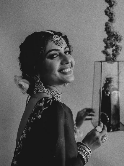 A joyful black and white portrait that perfectly captures the spirit of a bride. Her radiant smile shows the confidence that comes from feeling perfectly styled on her special day.