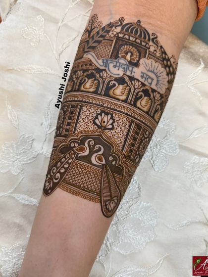 The full armband, showing the Sanskrit quote complemented by peacocks, swans, and lotus patterns.