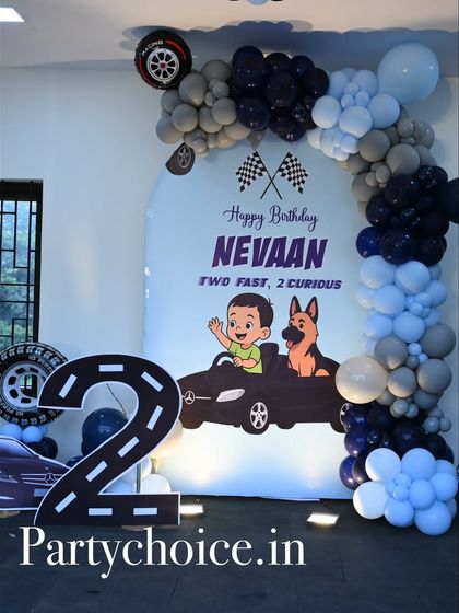 A closer look at the car-themed stage, showing the custom backdrop graphic and the large road-shaped number '2'.