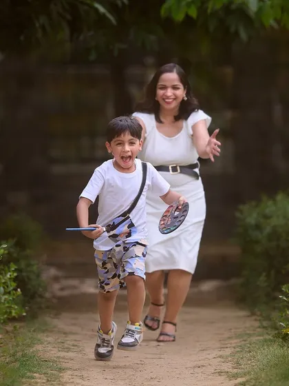 Capturing the pure excitement of a child during a playful chase with his mom. These candid, high-energy shots are perfect for showing a family's fun-loving spirit.