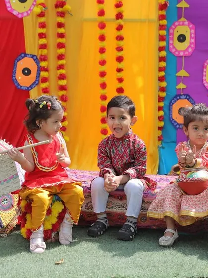 Three little stars dressed in beautiful ethnic wear, enjoying the Baisakhi festivities. These celebrations are filled with photo-worthy moments.