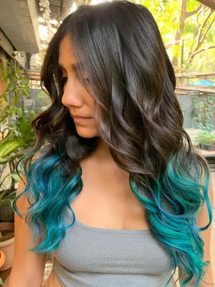 A side view of the ocean teal hair, showing how the color frames her face.